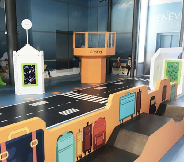 Airport-themed children’s play corner with baggage carousel and control tower