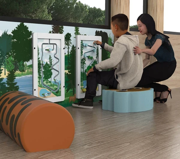 This image shows a boy playing with a educational wall game