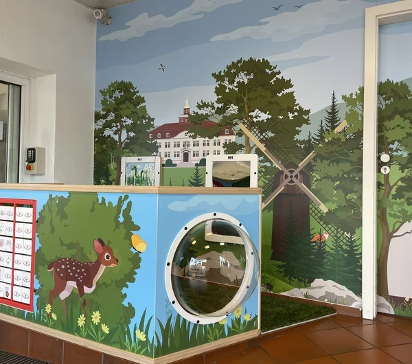 Interactive children’s play corner with farm-themed design, featuring a windmill, tunnel, and animal graphics