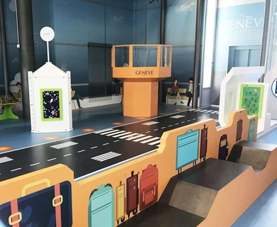 Airport-themed children’s play corner with baggage carousel and control tower