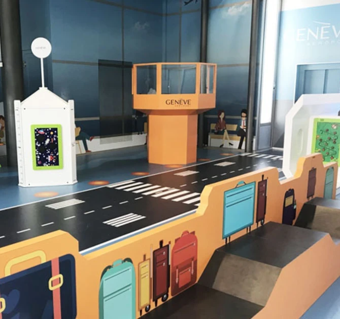 Airport-themed children’s play corner with baggage carousel and control tower