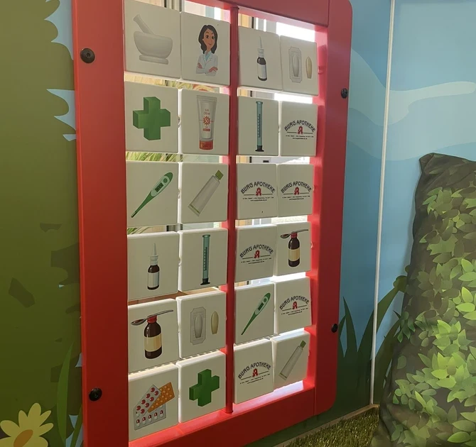 Interactive children’s play corner with farm-themed design, featuring a windmill, tunnel, and animal graphics