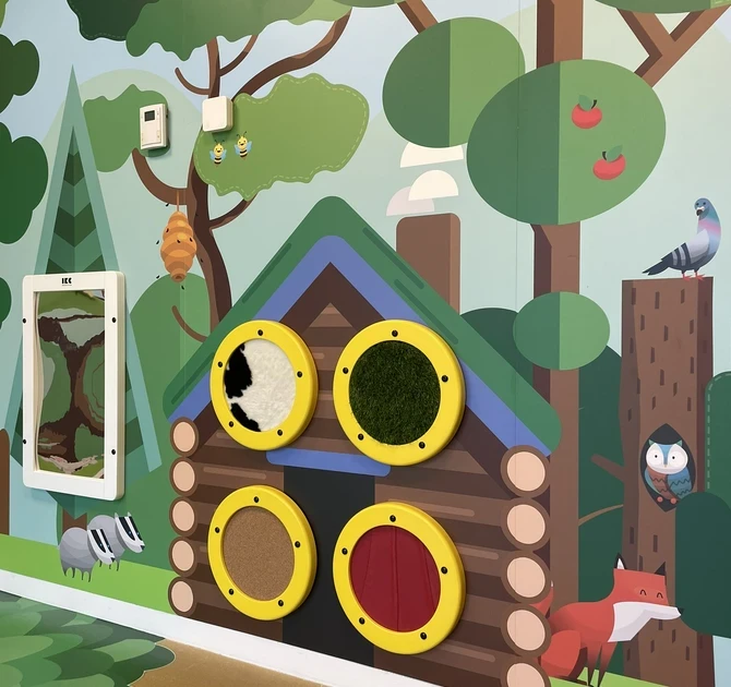 Tactile forest-themed play wall for children with interactive textures and animal illustrations by IKC