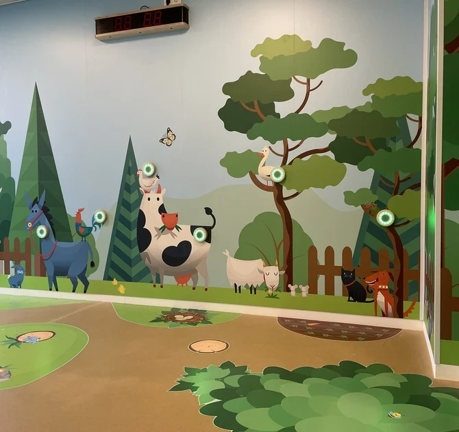 Farm-themed interactive play wall for children with sensor lights, animal illustrations and a nature-inspired EPDM floor